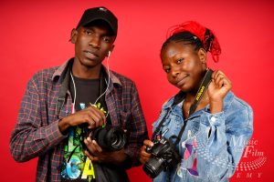 Photography student at Music and Film Academy Nairobi using a professional mirrorless camera for a school project