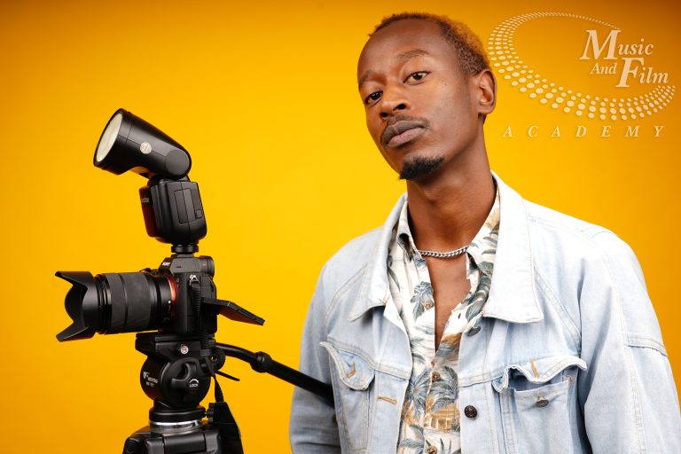 Photography student at Music and Film Academy learning manual camera settings and the exposure triangle in a professional studio.