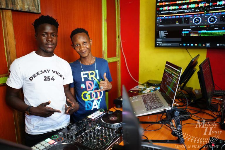 A wide-angle view of multiple students at Music And Film Academy Nairobi using identical Pioneer DJ setups and laptops to practice open-format mixing for corporate events and weddings.