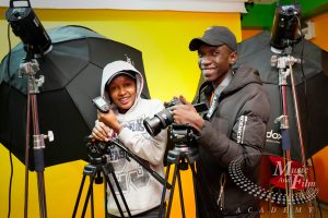 Aspiring creative entrepreneurs at Music and Film Academy Nairobi learning to use professional video production equipment.
