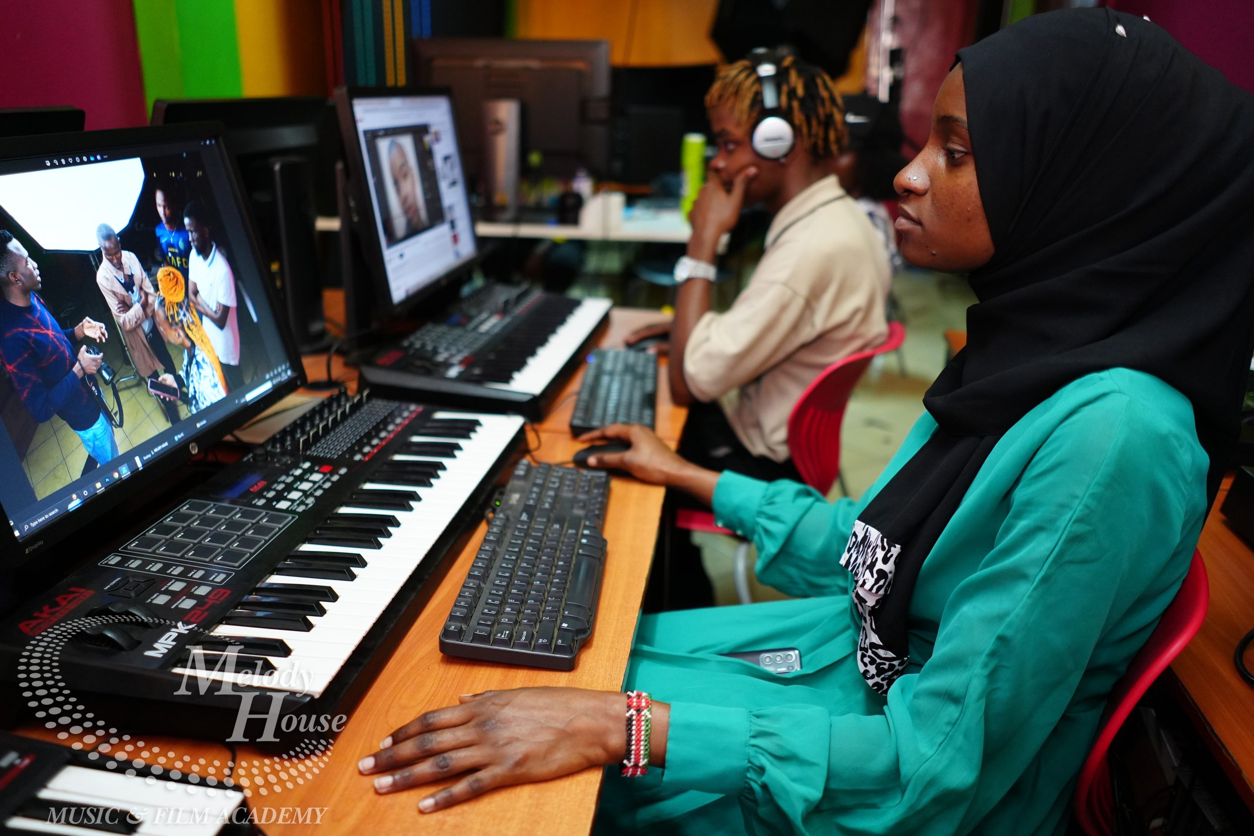 A female student utilizing a dedicated creative station during practical graphic design courses in Kenya.