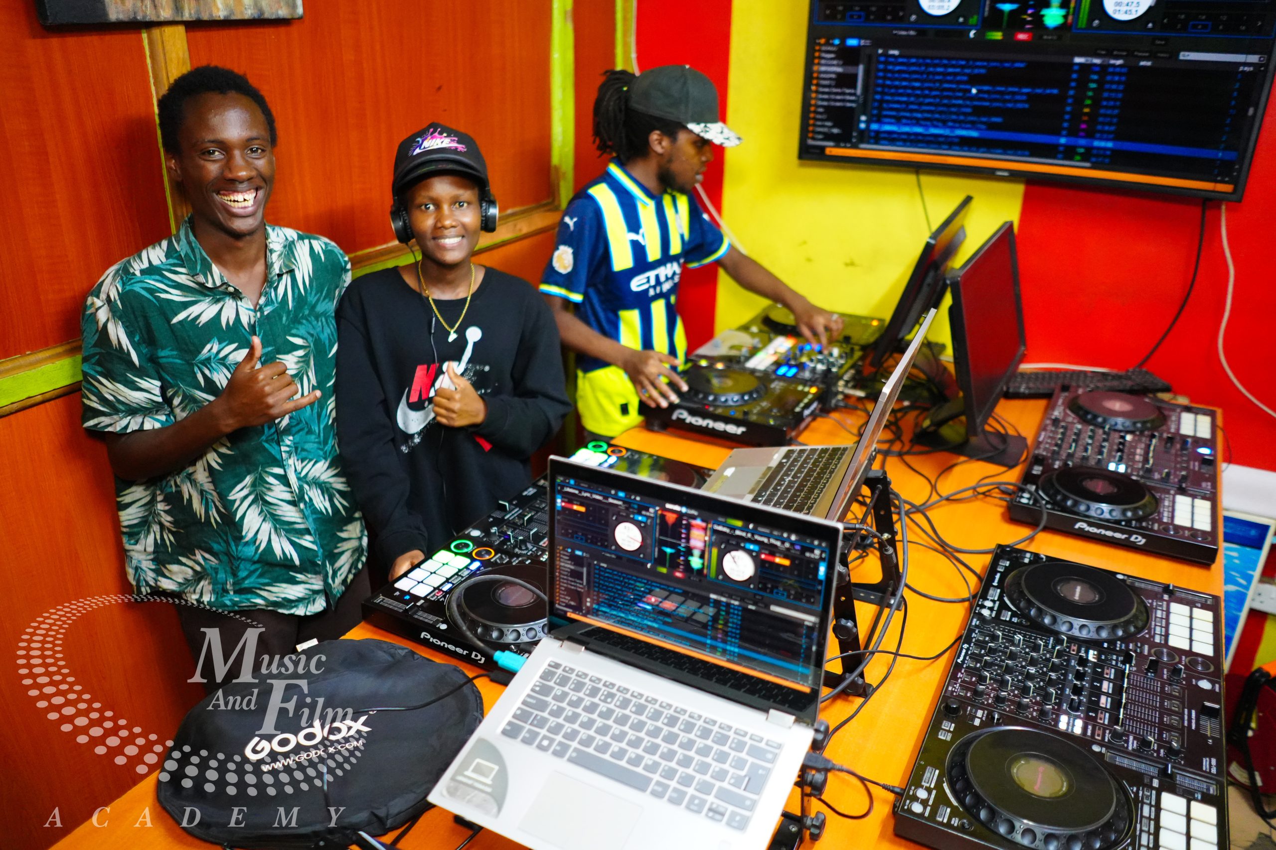students mastering djing vs music production using professional Pioneer CDJ-3000 media players and studio software setups at the Music And Film Academy campus in Nairobi CBD.
