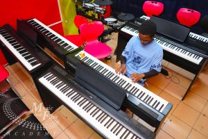 Student taking piano lessons on Yamaha digital keyboards at Music And Film Academy, ranked #1 best music school in Kenya