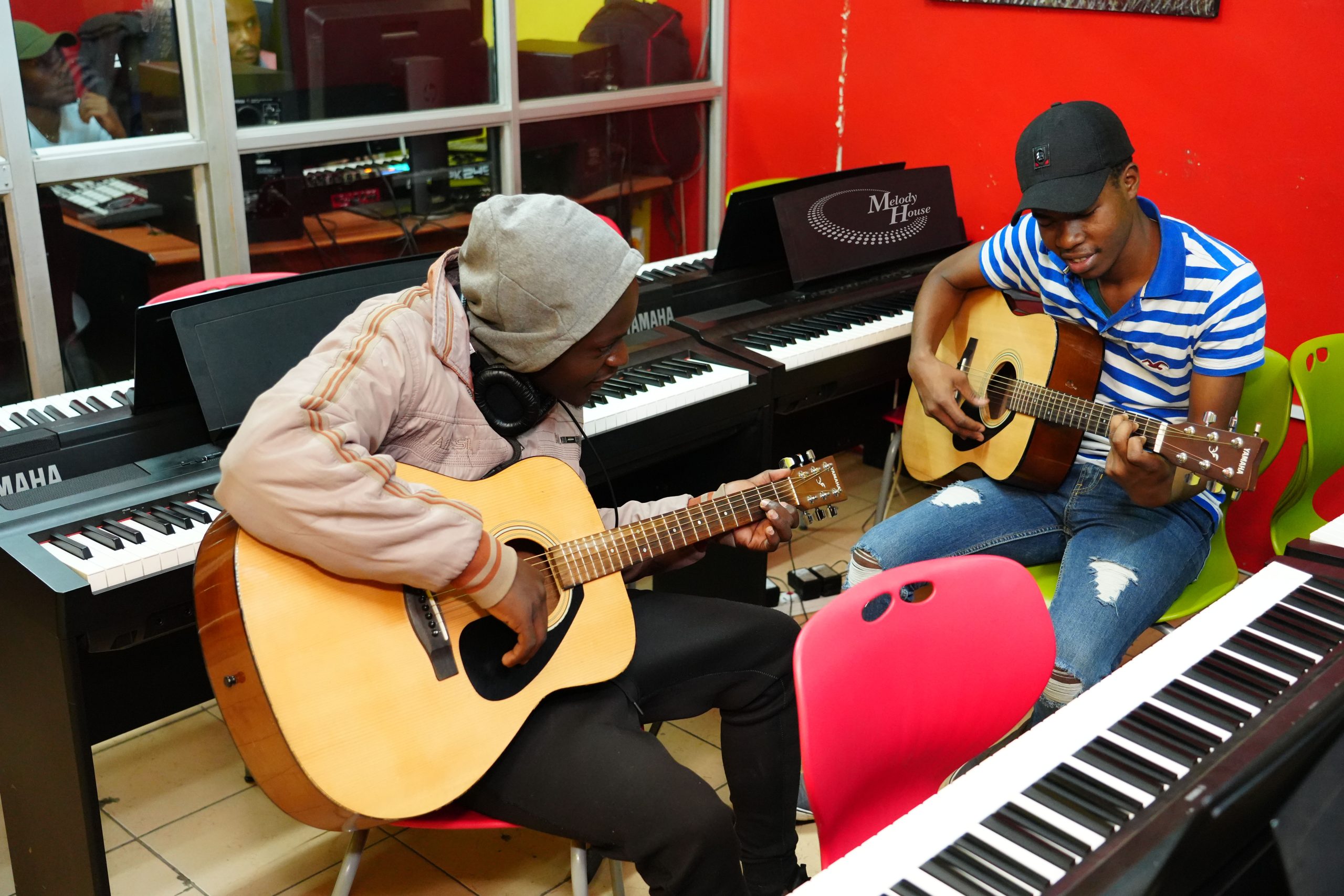 Students practicing acoustic guitar and piano at Music And Film Academy (Melody House) in Nairobi CBD